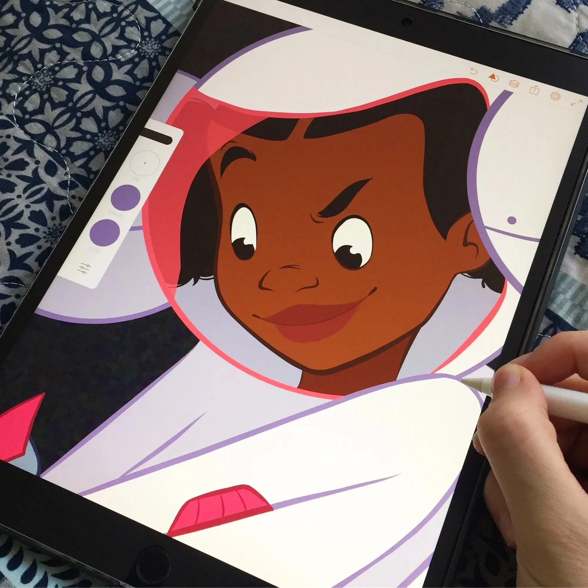 Kayla Coombs drawing one of the book's illustrations on a tablet